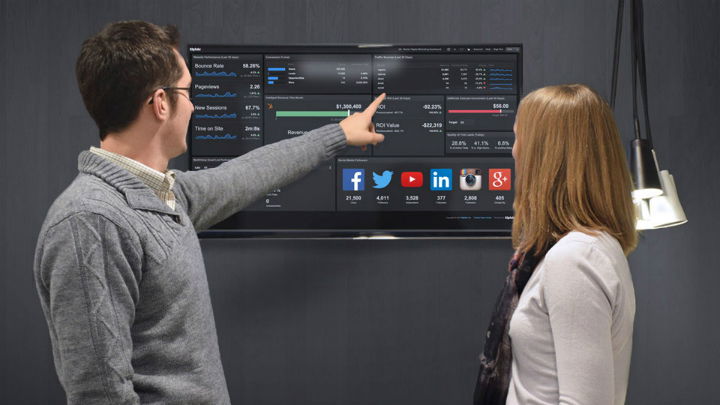 A man and a women looking at a dashboard