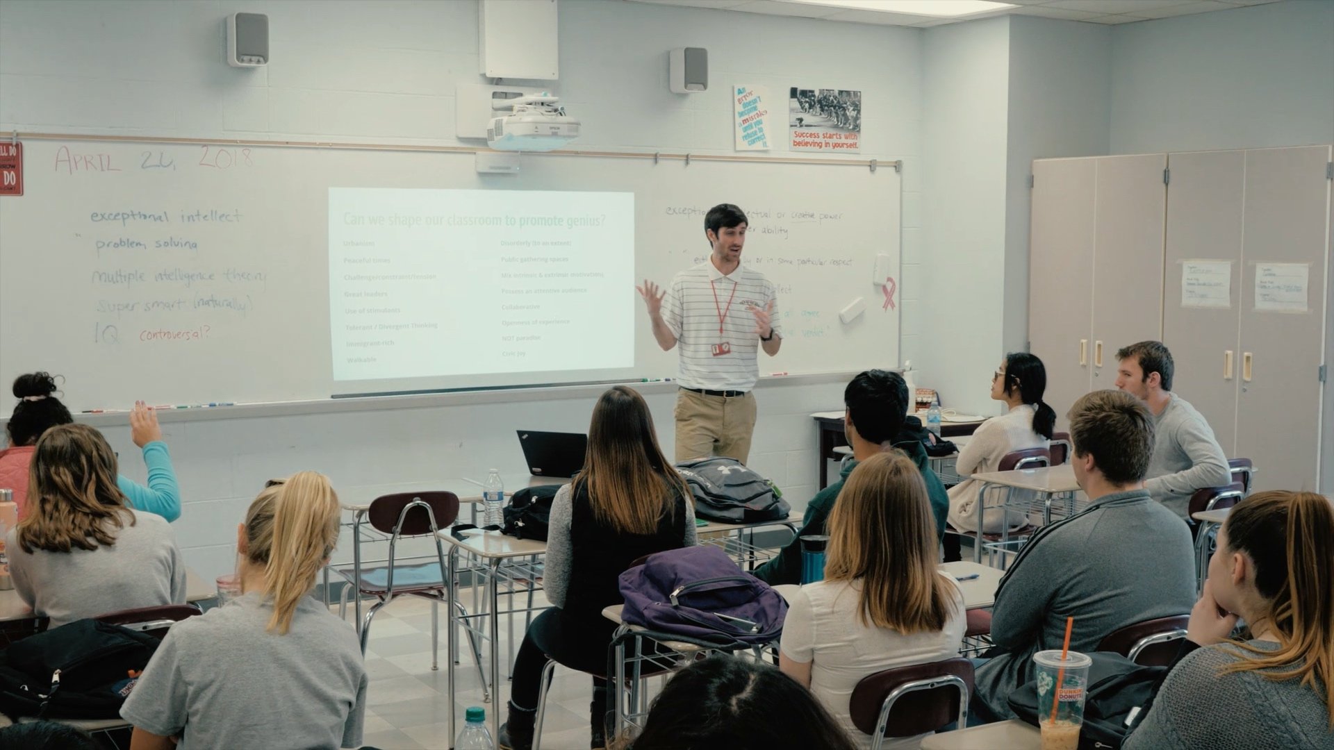 A teacher giving a lecture in a classroom full of students