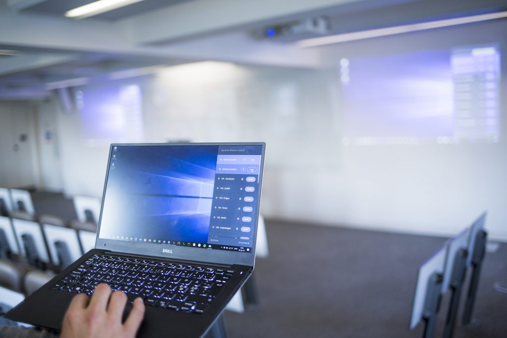 A laptop presenting wirelessly to a display connected with Airtame