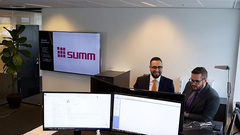 Two Summ accountants looking at a screen together